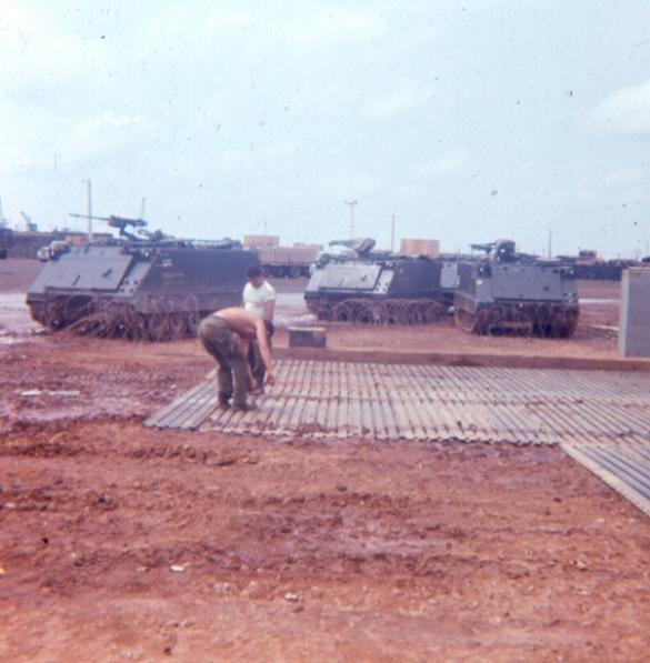 Left Photo - Laying Sections Of Portable Landing Strip For APC Parking Outside Guard Quarters - Robert Banbury is the GI With His Shirt Off -  Right Photo - Guards  Schaub, Burton and Tipton Washing APC On The Docks 