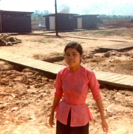 Left - One Of The Cleaning Girls With Outhouses In The  Background - Right - Another Cleaning Girl With  Urinal In The  Background