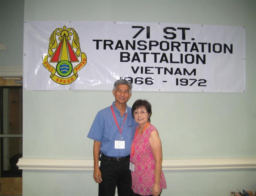 Wilfred & Thelma Lam standing in front of the 71st banner. - Photo courtesy of Wilfred & Thelma Lam.