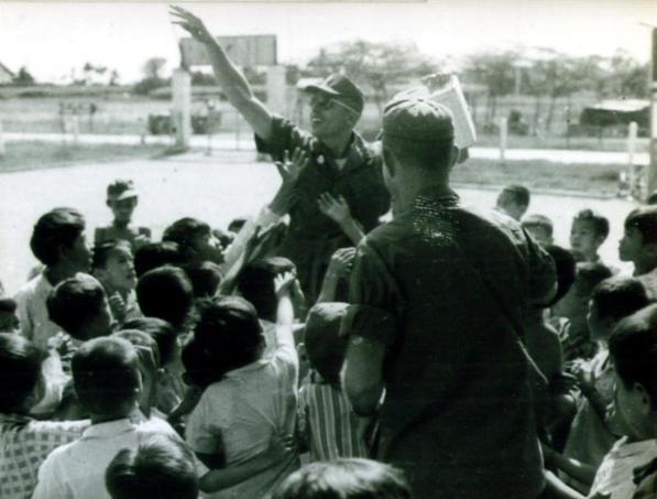 Lt Colucci Passing Out Candy To Children In Village Across From Camelot