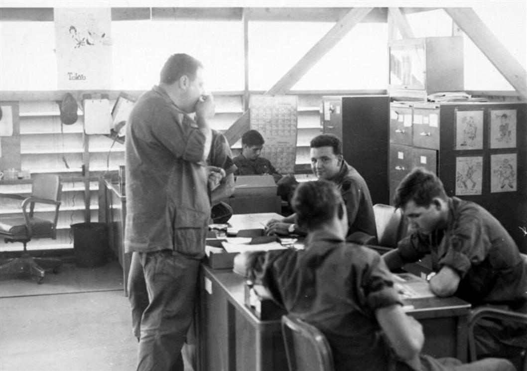 Left Photo - Working In Personnel At HQ - Sgt Panzarella Standing And Eating Something As He Always Was - Rex Dietz Sitting Behind The Typewriter Near The Wall - SP5 Peacock Reading - Don't Know The Names Of The Other Two GIs - Right Photo - SP5 David McNaught